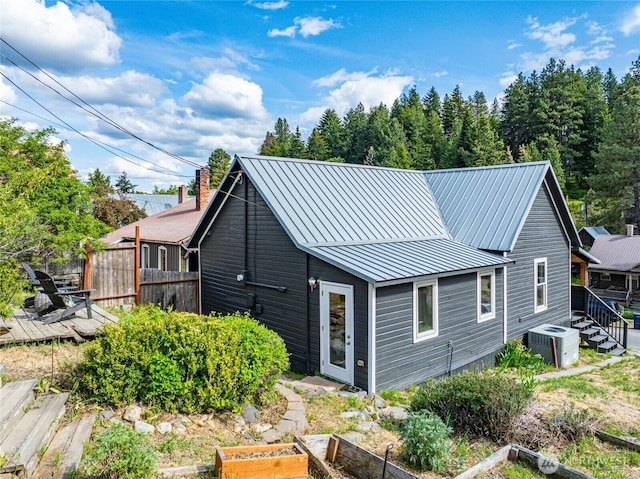 123 5th St, Roslyn, WA 98941 - rear view of property with cooling unit, a deck, a garden, metal roof, and a standing seam roof
