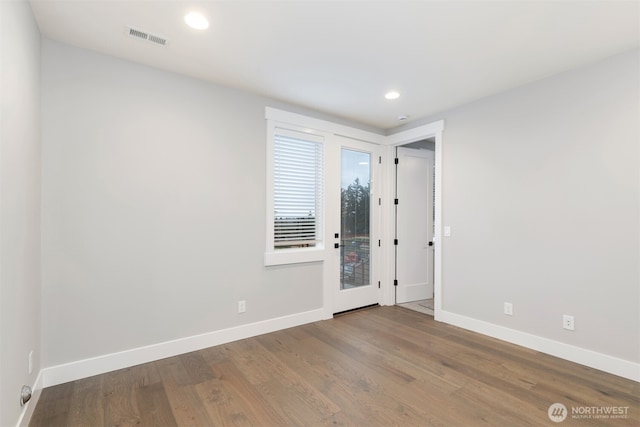 7570 S 129th Pl, Seattle, WA 98178 - unfurnished room featuring baseboards, wood finished floors, and recessed lighting