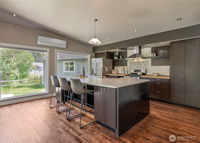 2710 N Lafayette, Bremerton, WA 98312 - kitchen featuring stainless steel appliances, a wall mounted AC, dark wood-type flooring, decorative backsplash, and vaulted ceiling
