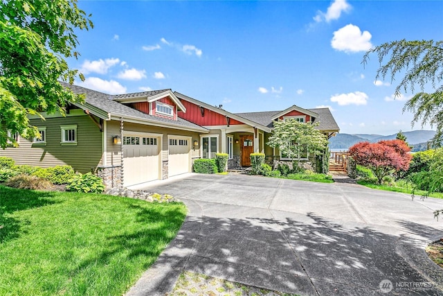 3178 Edgewood Ln, Bellingham, WA 98226 - craftsman-style home with a porch, asphalt driveway, stone siding, a garage, and a front lawn