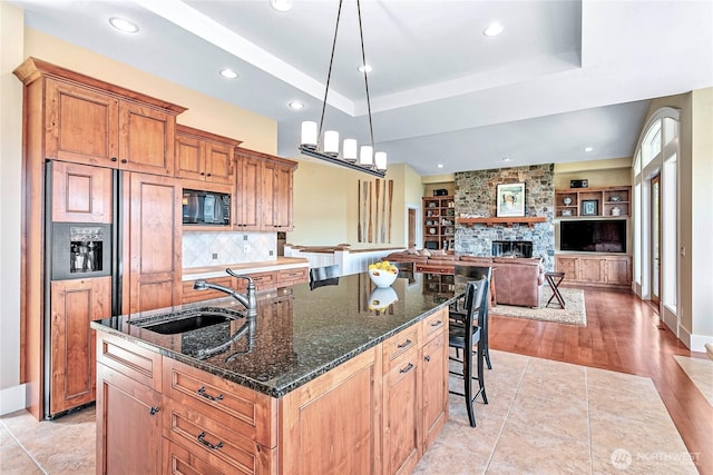 3178 Edgewood Ln, Bellingham, WA 98226 - kitchen featuring a sink, built in appliances, a kitchen island with sink, a kitchen bar, and a fireplace