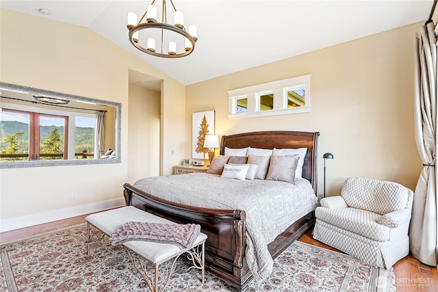 3178 Edgewood Ln, Bellingham, WA 98226 - bedroom featuring a chandelier, vaulted ceiling, wood finished floors, and baseboards
