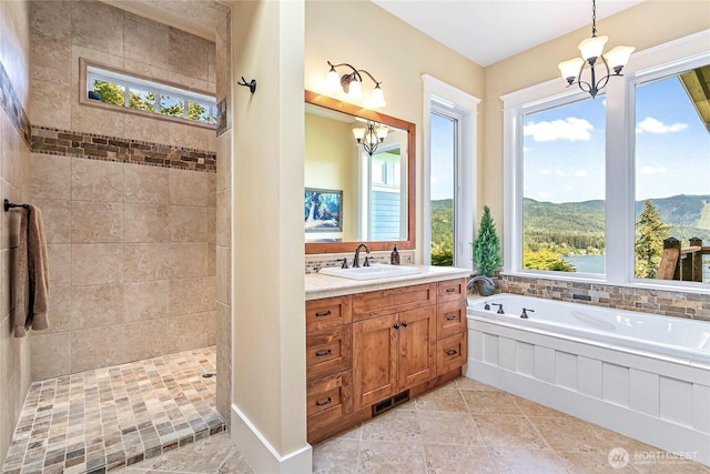 3178 Edgewood Ln, Bellingham, WA 98226 - bathroom with a chandelier, a garden tub, vanity, a tile shower, and a mountain view