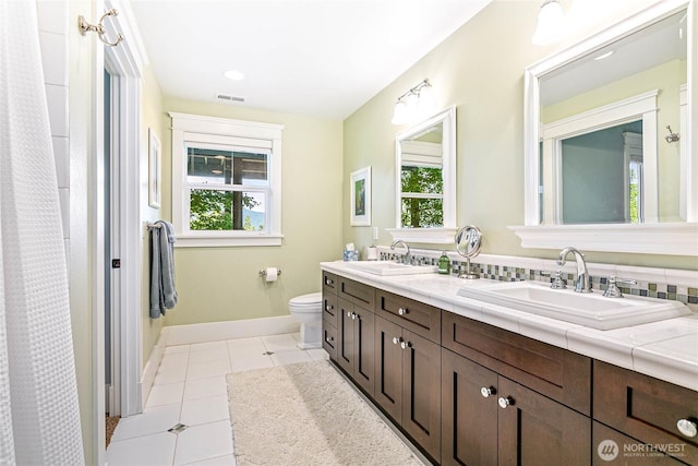3178 Edgewood Ln, Bellingham, WA 98226 - bathroom featuring plenty of natural light, toilet, double vanity, and tile patterned floors