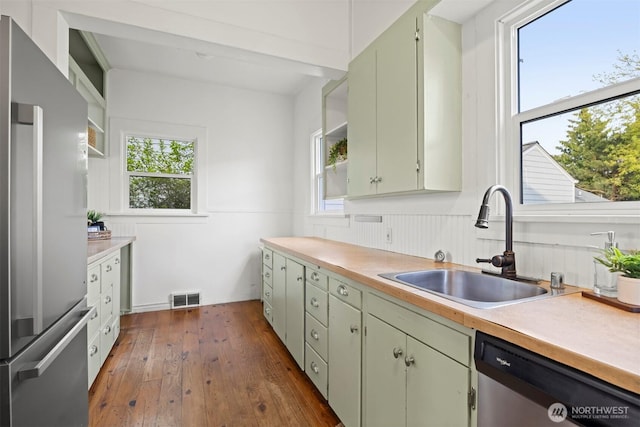 2416 Broadway, Bellingham, WA 98225 - kitchen with stainless steel appliances, open shelves, a sink, light countertops, and dark wood finished floors