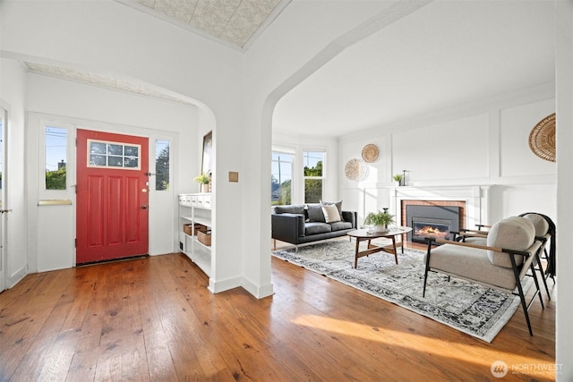 2416 Broadway, Bellingham, WA 98225 - foyer entrance featuring hardwood / wood-style flooring, a fireplace, and arched walkways