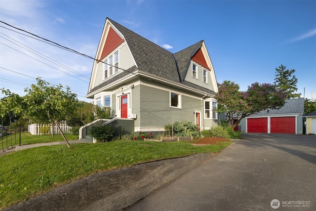 2416 Broadway, Bellingham, WA 98225 - view of front of house with a gambrel roof, a detached garage, a front lawn, and roof with shingles