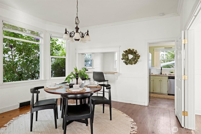 2416 Broadway, Bellingham, WA 98225 - dining space featuring a chandelier, wood-type flooring, ornamental molding, and a wainscoted wall