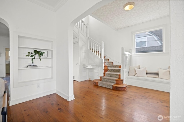 2416 Broadway, Bellingham, WA 98225 - foyer with arched walkways, hardwood / wood-style floors, stairs, ornamental molding, and baseboards