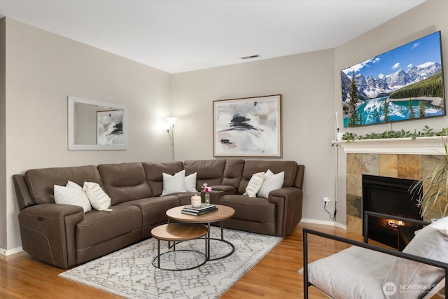 25356 SE 279th Pl, Maple Valley, WA 98038 - living area featuring wood finished floors, baseboards, and a tiled fireplace