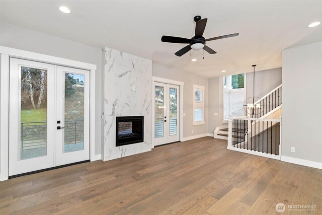 9513 38th St E, Edgewood, WA 98371 - unfurnished living room featuring french doors, wood finished floors, recessed lighting, baseboards, and a ceiling fan