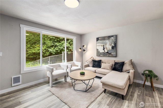8982 Wyvern Dr SE, Port Orchard, WA 98367 - living area featuring wood finished floors and heating unit