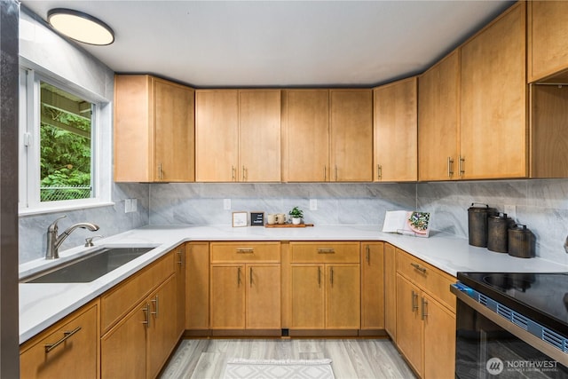 8982 Wyvern Dr SE, Port Orchard, WA 98367 - kitchen featuring electric range, light countertops, light wood-style flooring, and backsplash