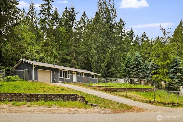 8982 Wyvern Dr SE, Port Orchard, WA 98367 - view of front facade with a garage, driveway, and a wooded view