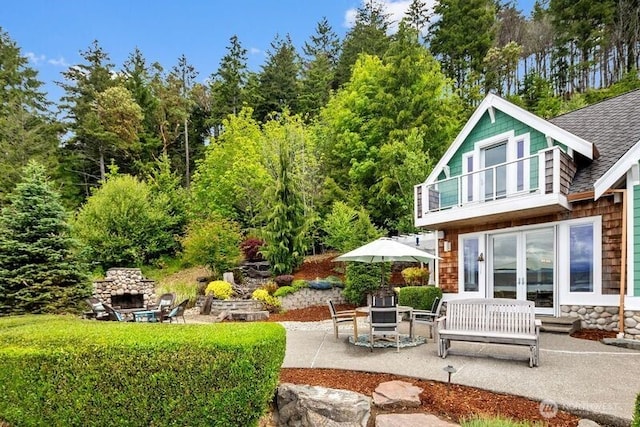 4590 E State Route 106, Union, WA 98592 - back of property featuring a patio, french doors, a shingled roof, and a balcony