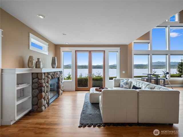 4590 E State Route 106, Union, WA 98592 - living room featuring plenty of natural light, a fireplace, wood finished floors, and recessed lighting