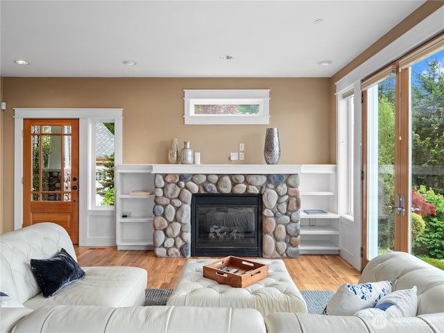 4590 E State Route 106, Union, WA 98592 - living room with wood finished floors, a stone fireplace, and recessed lighting