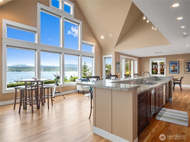 4590 E State Route 106, Union, WA 98592 - kitchen featuring a sink, baseboards, a center island with sink, light wood-style floors, and recessed lighting