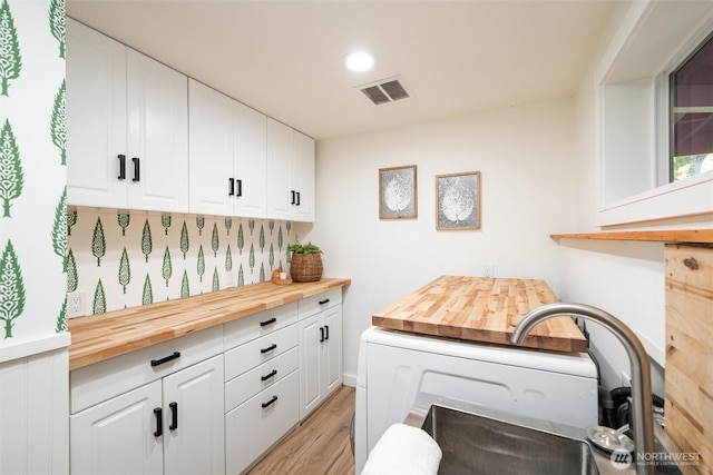 2553 Mackenzie Rd, Bellingham, WA 98226 - laundry room featuring light wood-style floors, recessed lighting, and cabinet space
