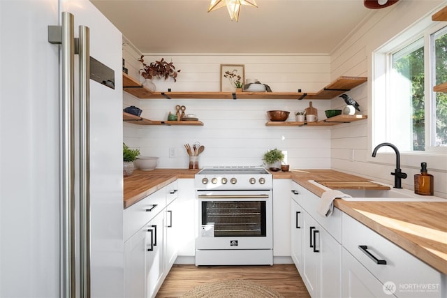 2553 Mackenzie Rd, Bellingham, WA 98226 - kitchen with white electric range oven, refrigerator, wood counters, and open shelves