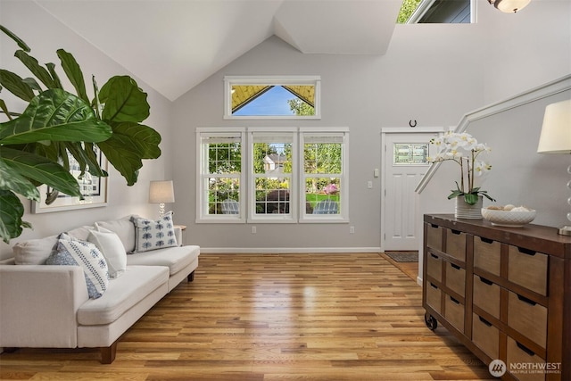 20160 Bue Rund Loop NE, Poulsbo, WA 98370 - living room with high vaulted ceiling, light wood finished floors, and baseboards