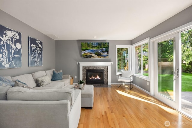 20160 Bue Rund Loop NE, Poulsbo, WA 98370 - living room featuring light wood-style floors, a fireplace, and baseboards