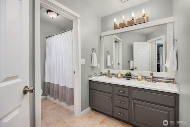 20160 Bue Rund Loop NE, Poulsbo, WA 98370 - bathroom with double vanity, tile patterned floors, a shower with curtain, and baseboards