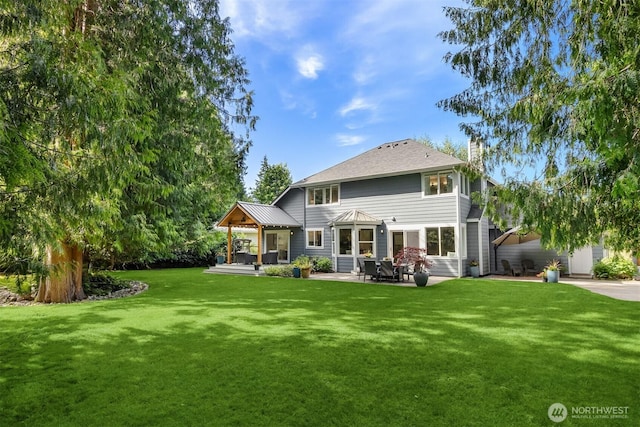 20160 Bue Rund Loop NE, Poulsbo, WA 98370 - rear view of house featuring a chimney, a yard, and a patio area