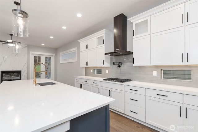 7545 S 129th Pl, Seattle, WA 98178 - kitchen with a sink, wall chimney exhaust hood, stainless steel gas cooktop, recessed lighting, and a high end fireplace