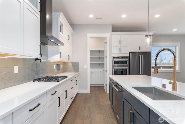 7545 S 129th Pl, Seattle, WA 98178 - kitchen featuring a sink, wall chimney exhaust hood, appliances with stainless steel finishes, white cabinets, and dark wood-style floors