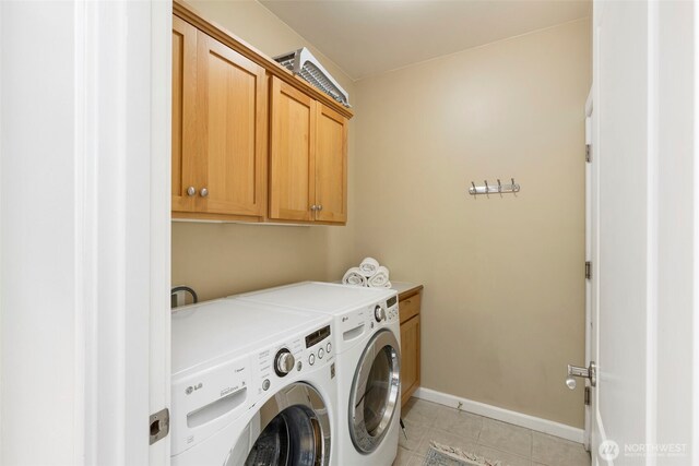 31199 Laughing Dog Ave NE, Poulsbo, WA 98370 - laundry room with cabinet space, light tile patterned floors, and separate washer and dryer
