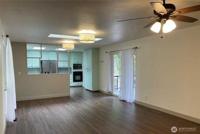 463 Humble Hill Rd, Sequim, WA 98382 - unfurnished living room with dark wood-style floors, baseboards, and a ceiling fan