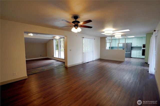 463 Humble Hill Rd, Sequim, WA 98382 - unfurnished living room with dark wood-type flooring, a ceiling fan, and baseboards