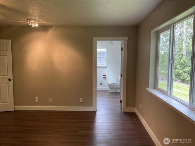463 Humble Hill Rd, Sequim, WA 98382 - unfurnished room featuring dark wood-style floors, baseboards, and a textured ceiling