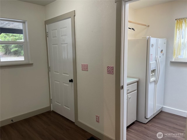463 Humble Hill Rd, Sequim, WA 98382 - laundry room with wood finished floors and baseboards