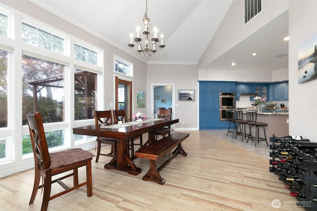 190 Twin Peaks Rd, Selah, WA 98942 - dining area with high vaulted ceiling, a chandelier, light wood-type flooring, and ornamental molding