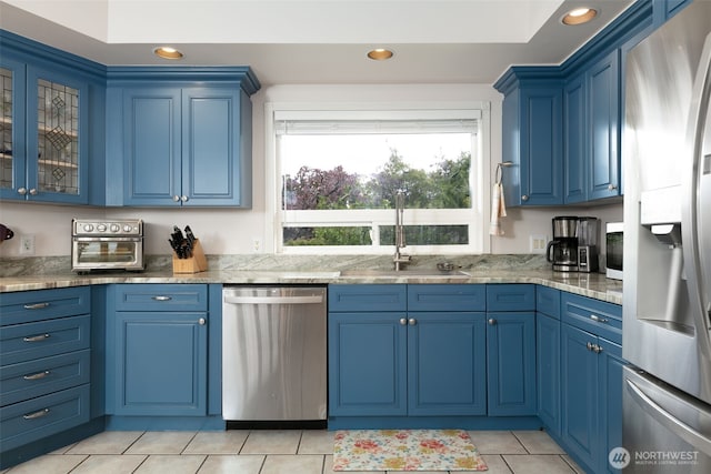 190 Twin Peaks Rd, Selah, WA 98942 - kitchen featuring appliances with stainless steel finishes, blue cabinetry, a sink, recessed lighting, and light tile patterned flooring