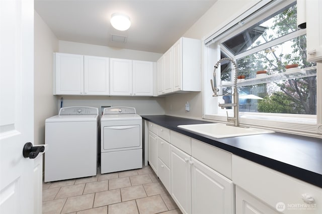 190 Twin Peaks Rd, Selah, WA 98942 - washroom featuring washing machine and clothes dryer, cabinet space, and light tile patterned flooring