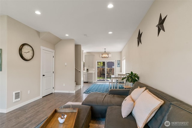 610 Laura Ln, Ellensburg, WA 98926 - living area with dark wood-style flooring, recessed lighting, baseboards, heating unit, and a chandelier