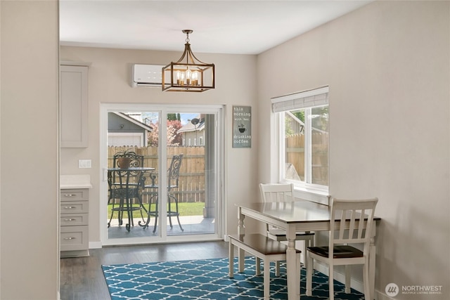 610 Laura Ln, Ellensburg, WA 98926 - dining space featuring a chandelier, wood finished floors, a wall unit AC, and baseboards