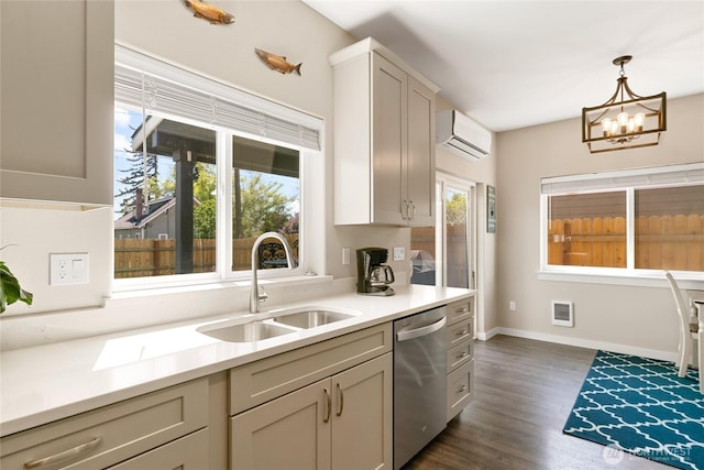 610 Laura Ln, Ellensburg, WA 98926 - kitchen with dishwasher, a sink, a wall unit AC, a chandelier, and dark wood finished floors
