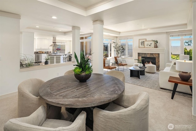 221 5th Ave S Unit E303, Kirkland, WA 98033 - dining room featuring a tray ceiling, recessed lighting, light carpet, a tile fireplace, and ornate columns