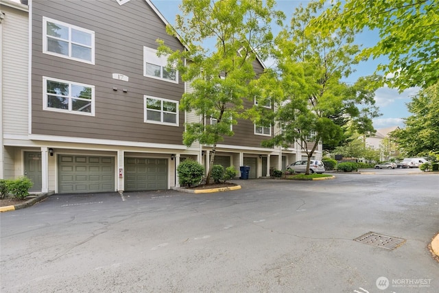 3116 164th St SW Unit 1704, Lynnwood, WA 98087 - view of front of property with an attached garage and driveway