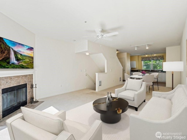 3116 164th St SW Unit 1704, Lynnwood, WA 98087 - living room featuring track lighting, ceiling fan, a tile fireplace, and light carpet