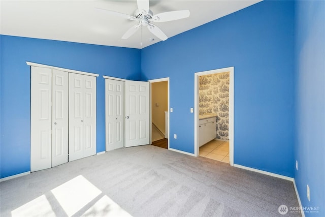 3116 164th St SW Unit 1704, Lynnwood, WA 98087 - unfurnished bedroom with carpet floors, multiple closets, lofted ceiling, baseboards, and ensuite bathroom