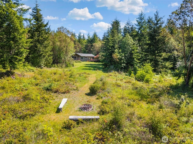 512 Snagstead Way, Port Townsend, WA 98368 - view of yard featuring an outdoor fire pit and a view of trees