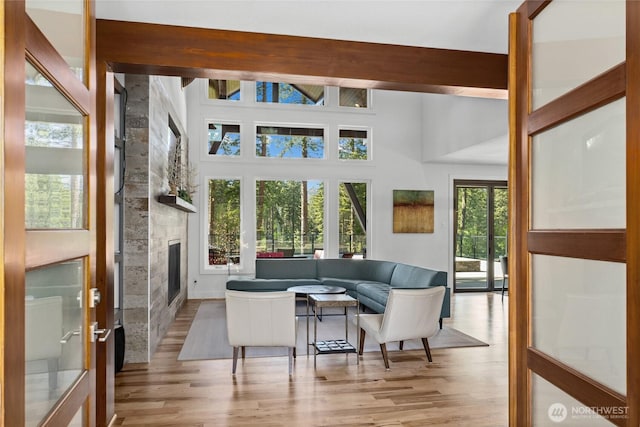 501 Maple Leaf Loop, Cle Elum, WA 98922 - living area featuring wood finished floors, a large fireplace, french doors, and beam ceiling