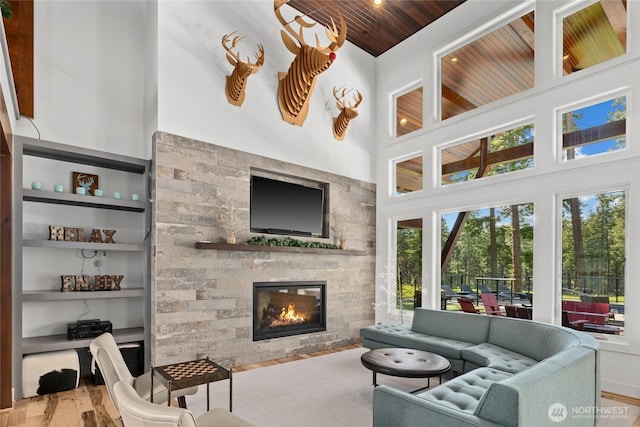 501 Maple Leaf Loop, Cle Elum, WA 98922 - living area with a stone fireplace, wood finished floors, built in shelves, a towering ceiling, and wooden ceiling