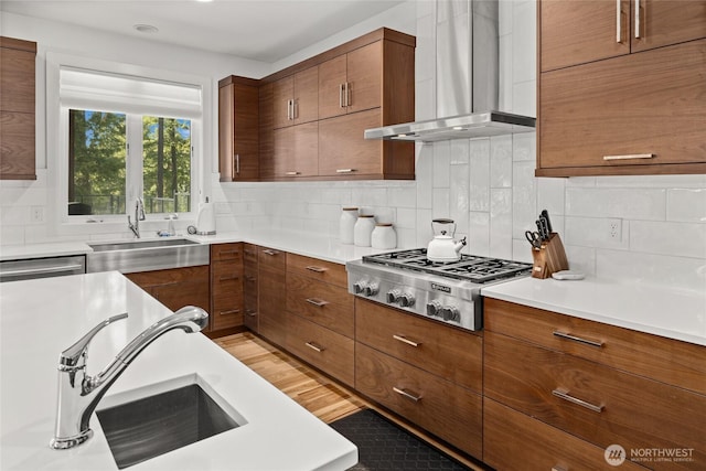 501 Maple Leaf Loop, Cle Elum, WA 98922 - kitchen featuring appliances with stainless steel finishes, wall chimney range hood, a sink, and brown cabinets