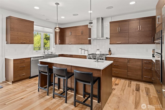 501 Maple Leaf Loop, Cle Elum, WA 98922 - kitchen with wall chimney exhaust hood, appliances with stainless steel finishes, light wood-style flooring, a kitchen breakfast bar, and recessed lighting